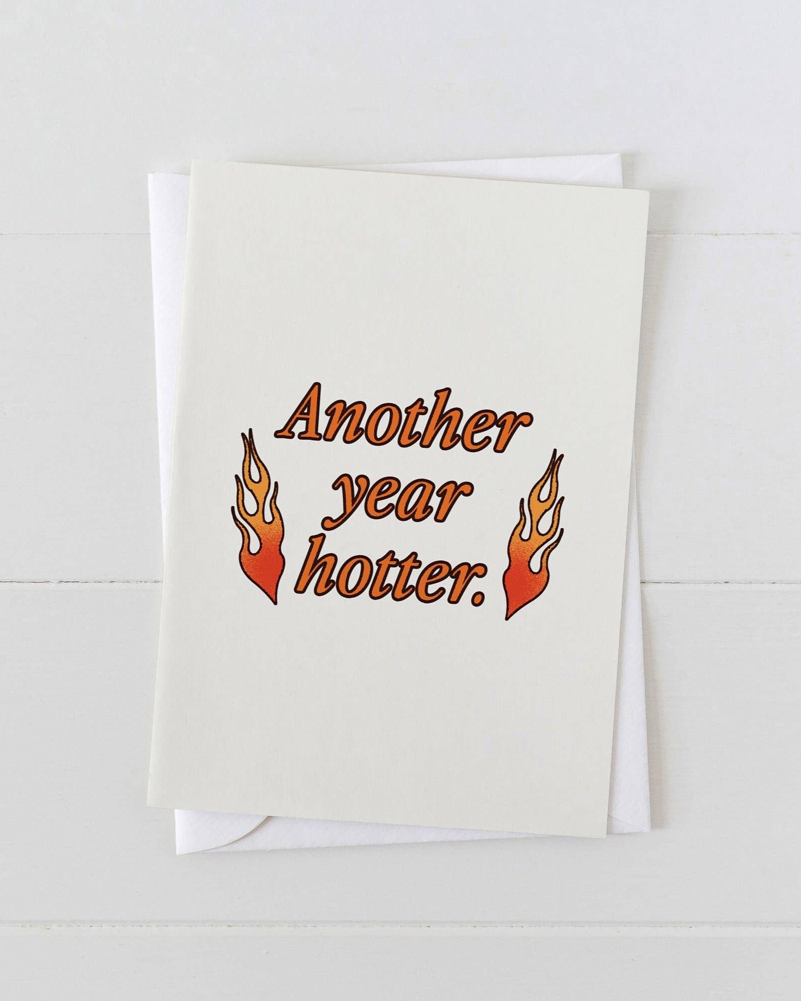 Greeting card with 'Another year hotter.' text and flames on a white background