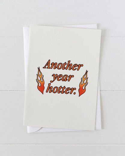 Greeting card with 'Another year hotter.' text and flames on a white background