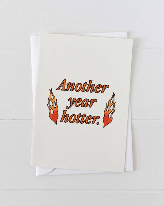 Greeting card with 'Another year hotter.' text and flames on a white background