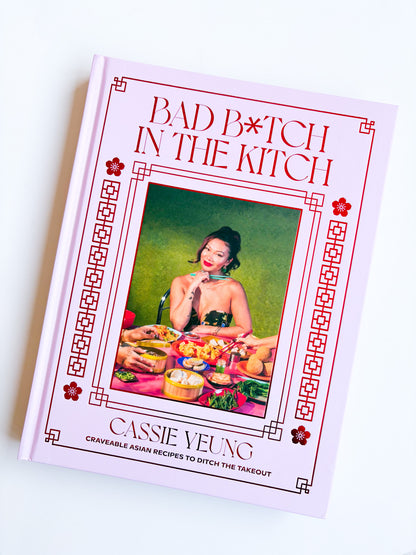 Cookbook titled 'Bad Bitch in the Kitch' by Cassie Yeung on a white background