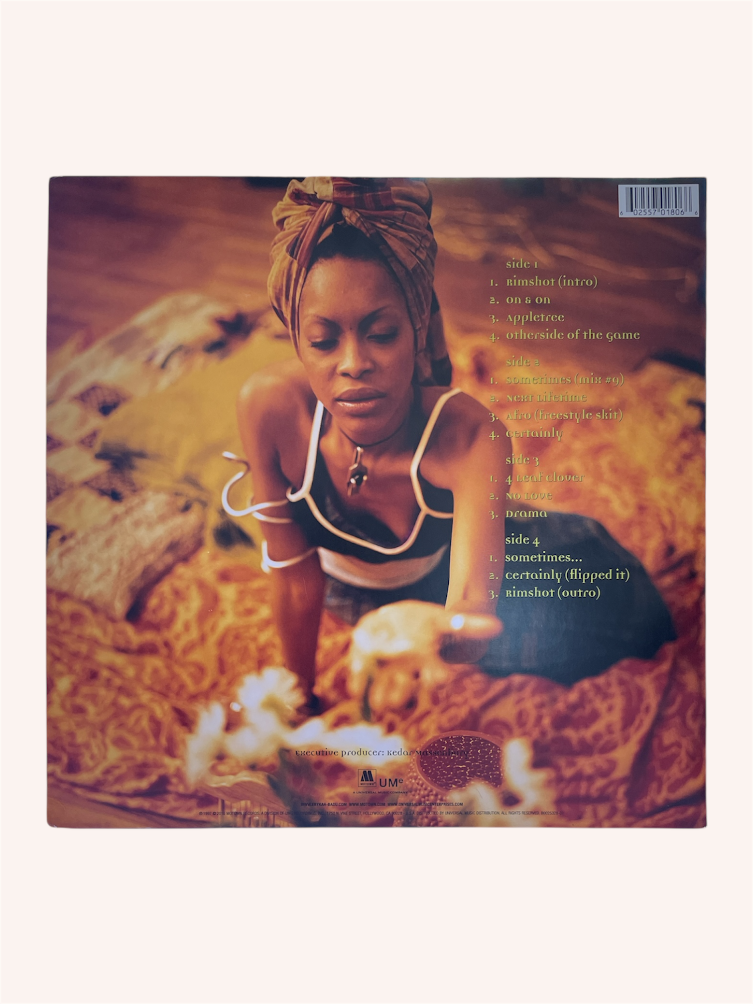 Vinyl record cover with a person sitting on a textured surface, featuring text and a logo. Baduizm Vinyl Record - Erykah Badu