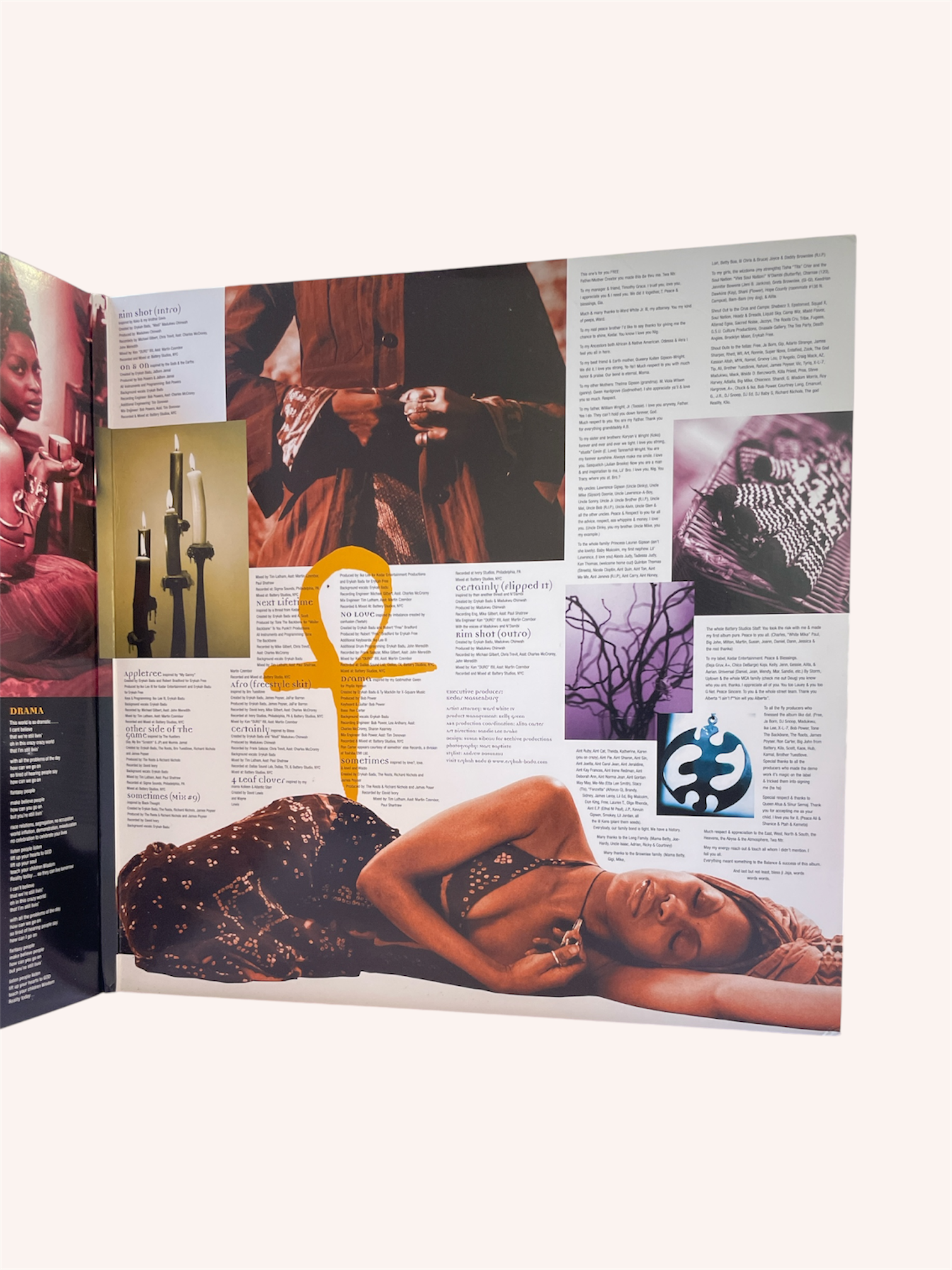 Open book with images and text, featuring a woman lying down and an Ankh symbol. Baduizm Vinyl Record - Erykah Badu