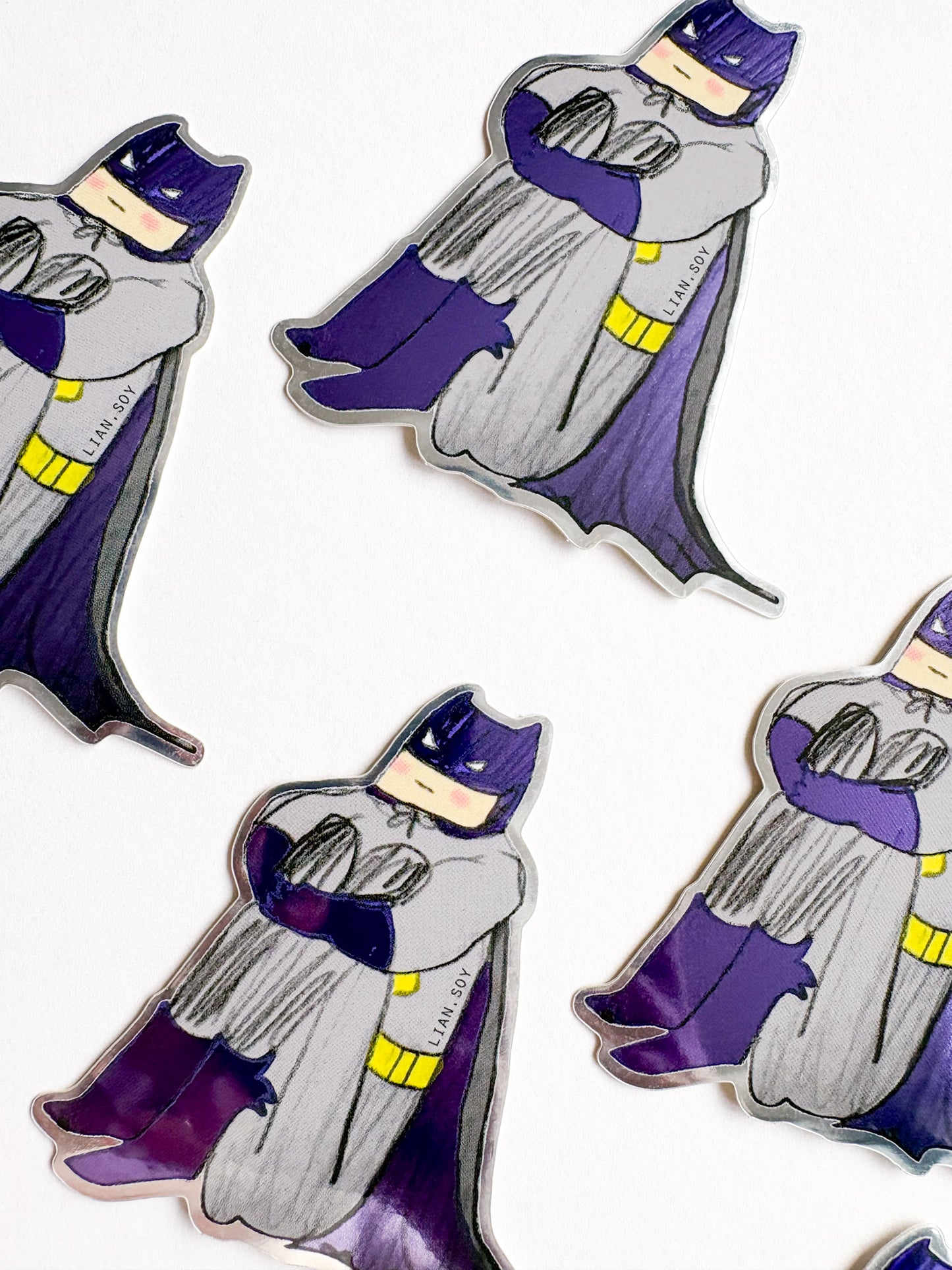 Sticker of a character in a purple cape and hat on a white background