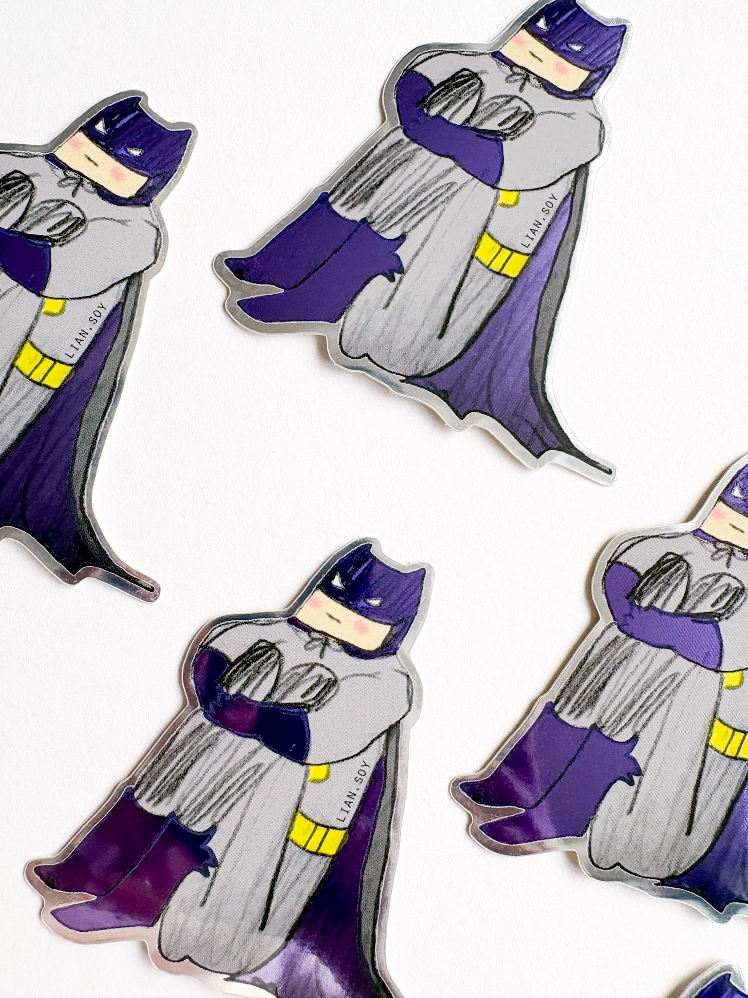 Sticker of a character in a purple cape and hat on a white background