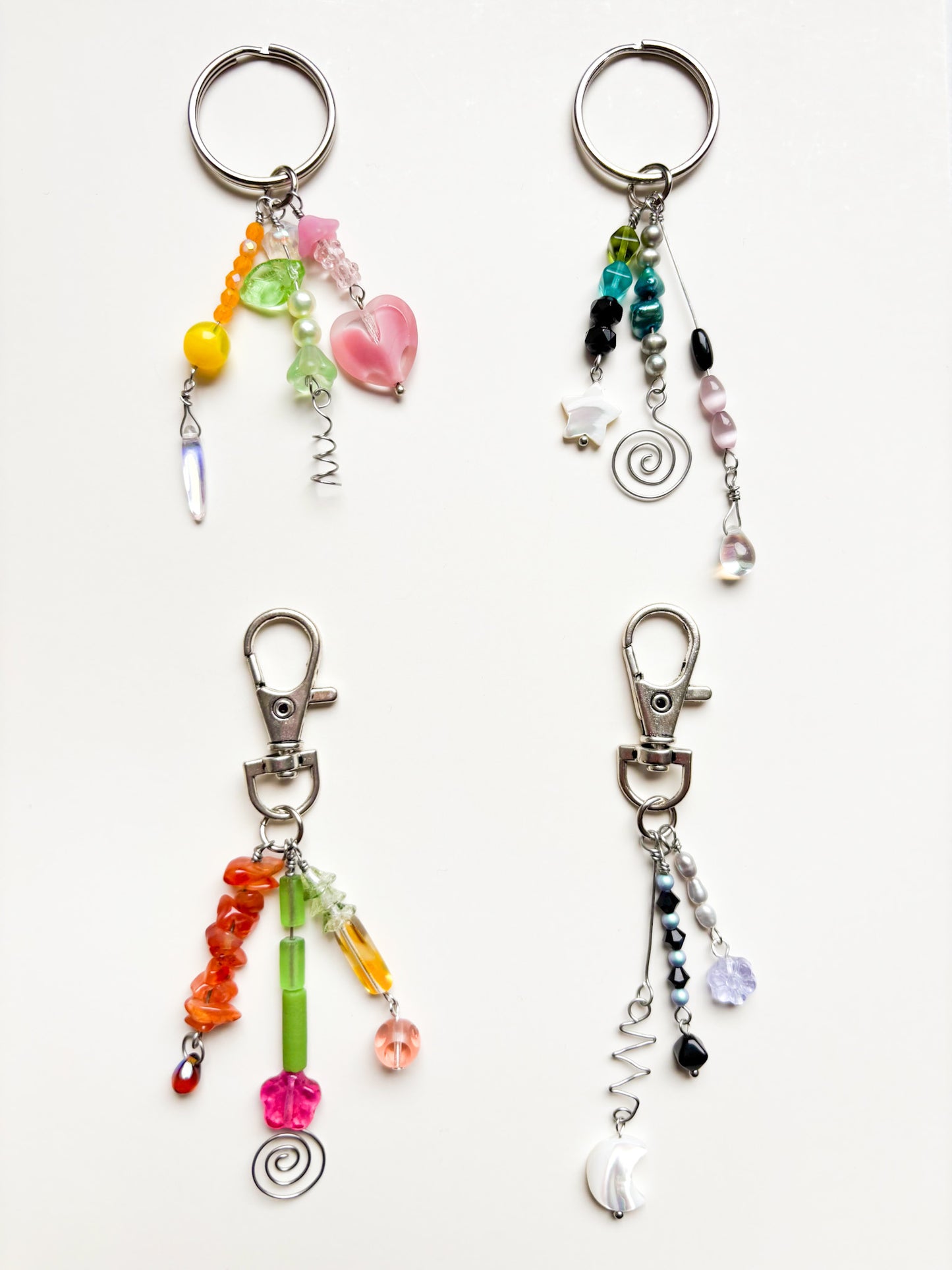 Four colorful beaded keychains on a white background