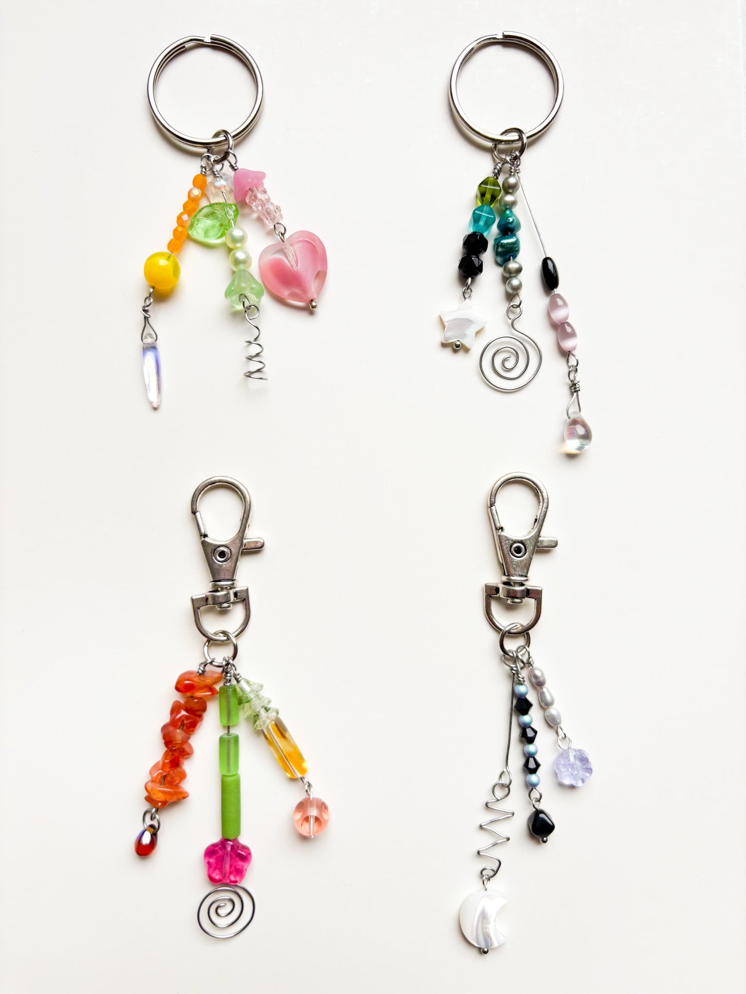 Four colorful beaded keychains on a white background
