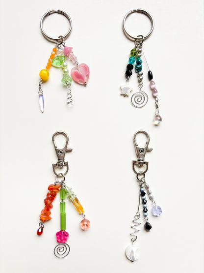 Four colorful beaded keychains on a white background