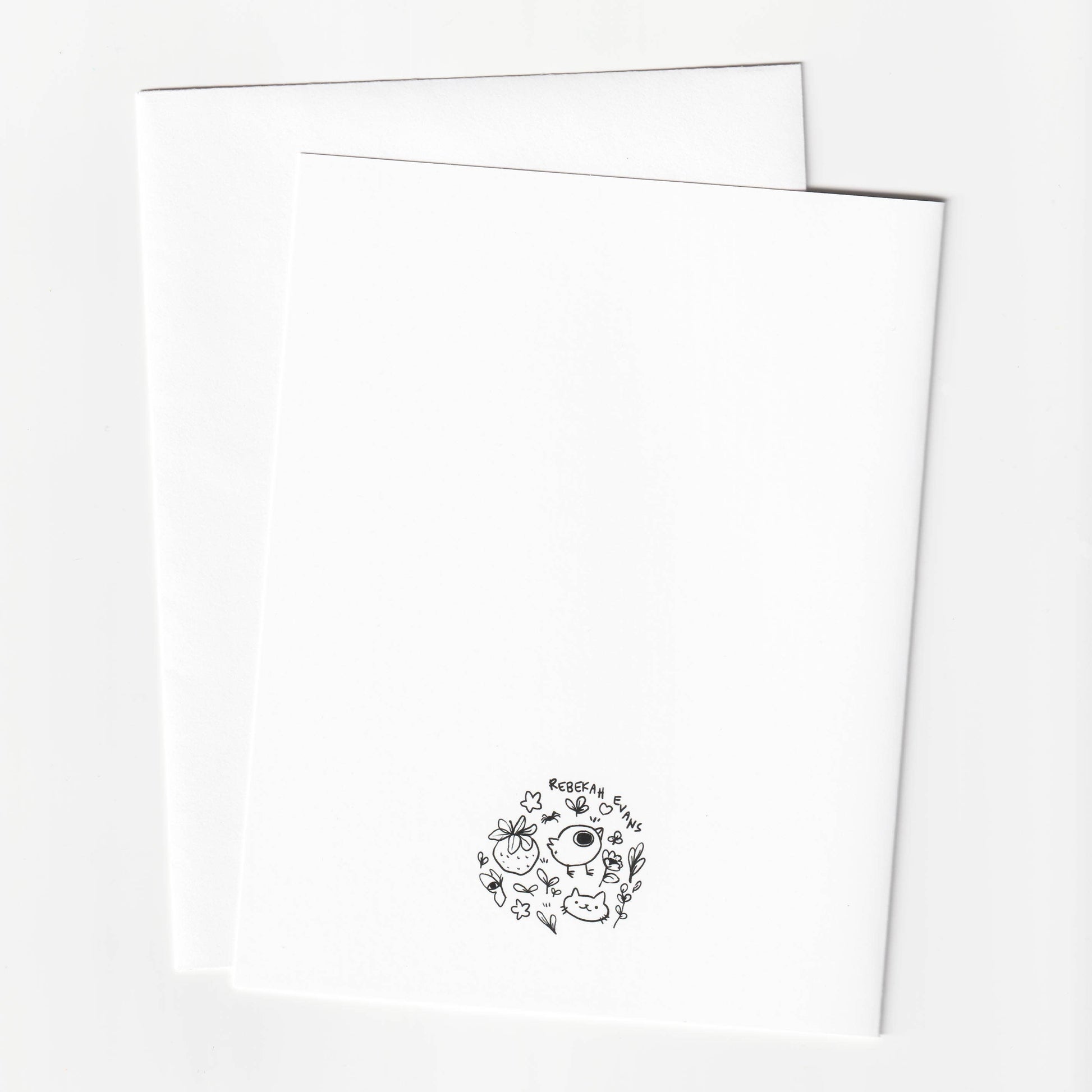 Two white sheets of paper with a black logo on a white background