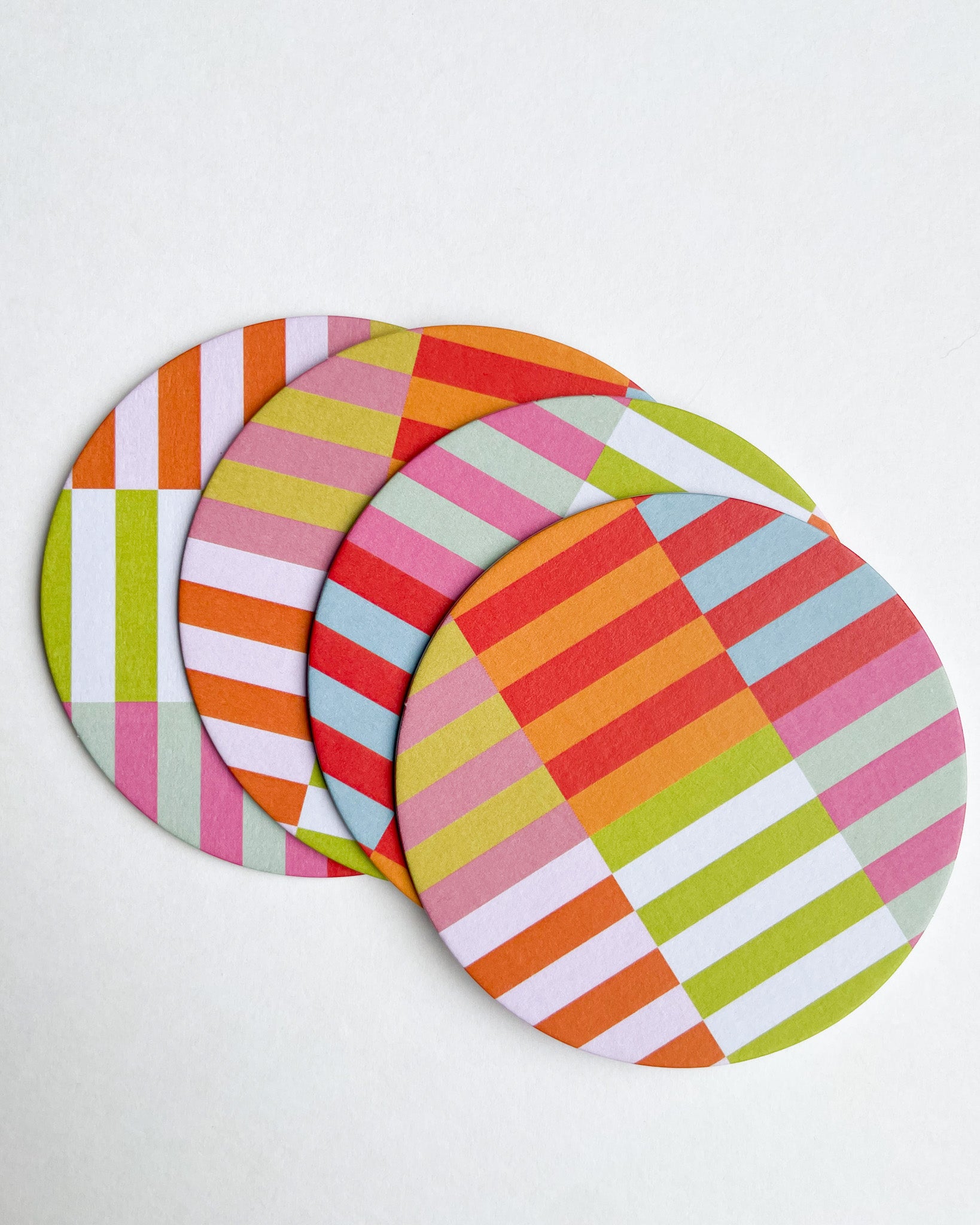 Set of colorful striped coasters on a white background