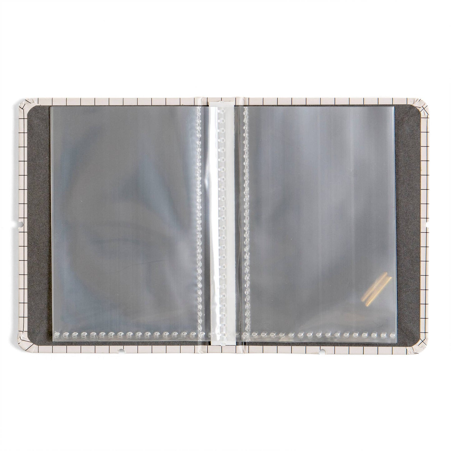 An open plastic binder or album page protector cover with clear plastic sleeves on a white background.