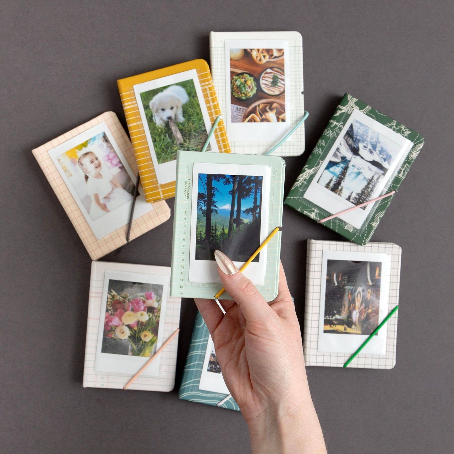 Collection of small photo frames with various images on a gray background