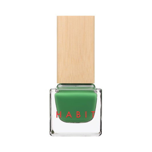 A bottle of green nail polish with a light wood-grain textured cap, featuring the brand name 'HABIT' in red text on the clear glass bottle, set against a plain white background.
