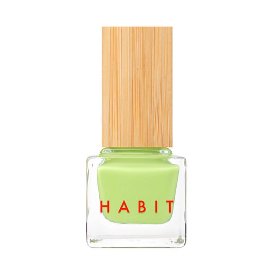 Green nail polish bottle with a wooden cap on a white background
