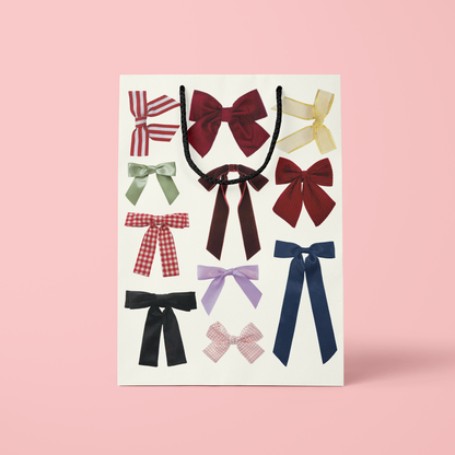 Set of colorful bows on a pink background