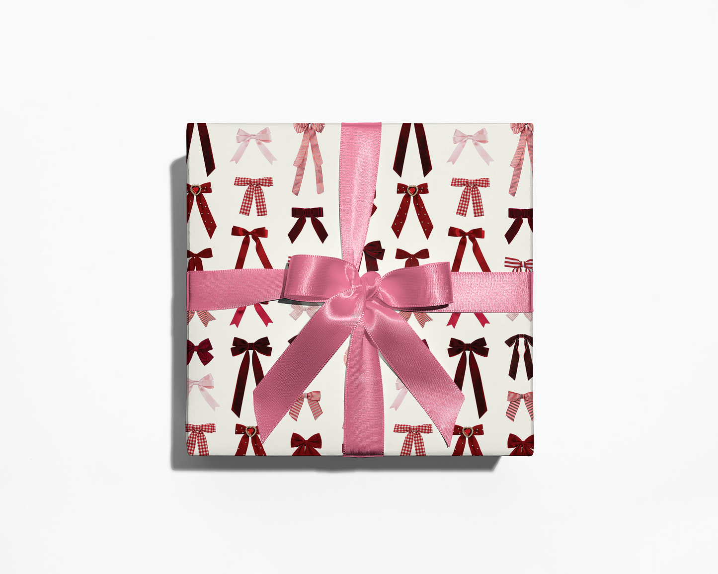 Gift box with pink ribbon and bow on a white background
