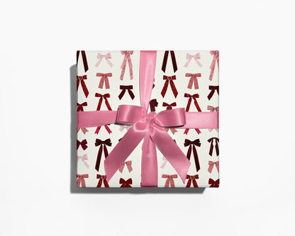 Gift box with pink ribbon and bow on a white background