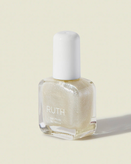 Nail polish bottle with 'RUTH' branding on a light beige background, Bride Pearl Nail Polish