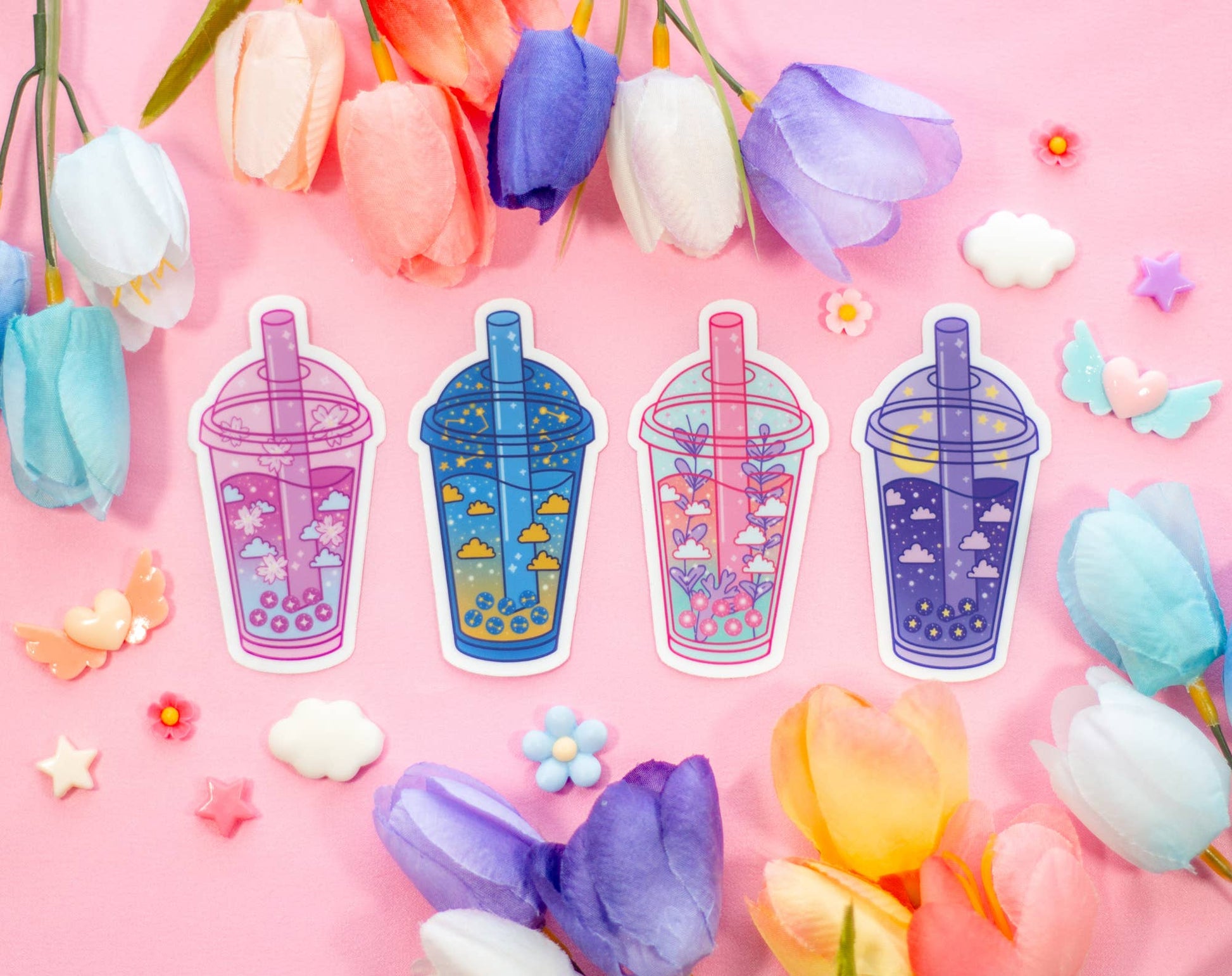 Sticker designs of colorful drinks with straws on a pink background with flowers.