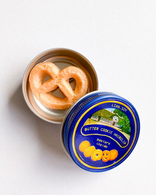 Butter cookie in a tin with a blue label on a white background