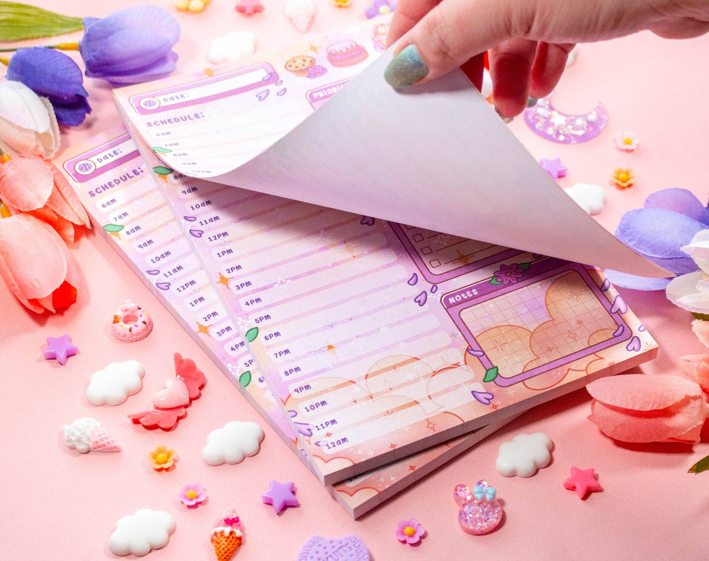Notebook with stickers on a pink background