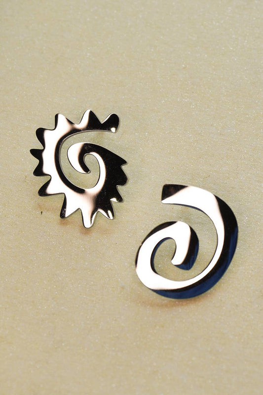 Two silver spiral earrings on a beige background