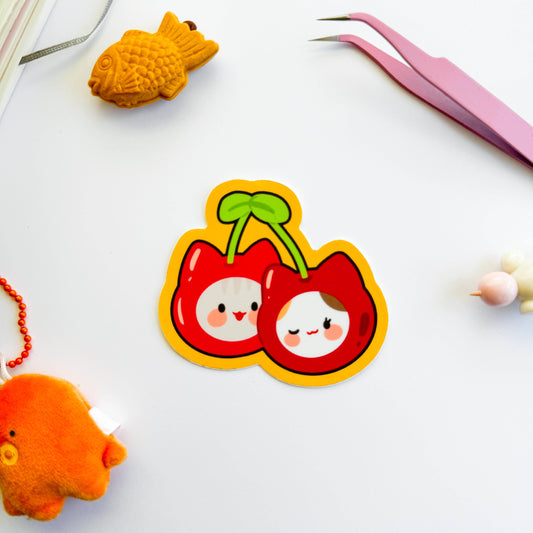 Cartoon cherry character sticker on a white background with small toys.