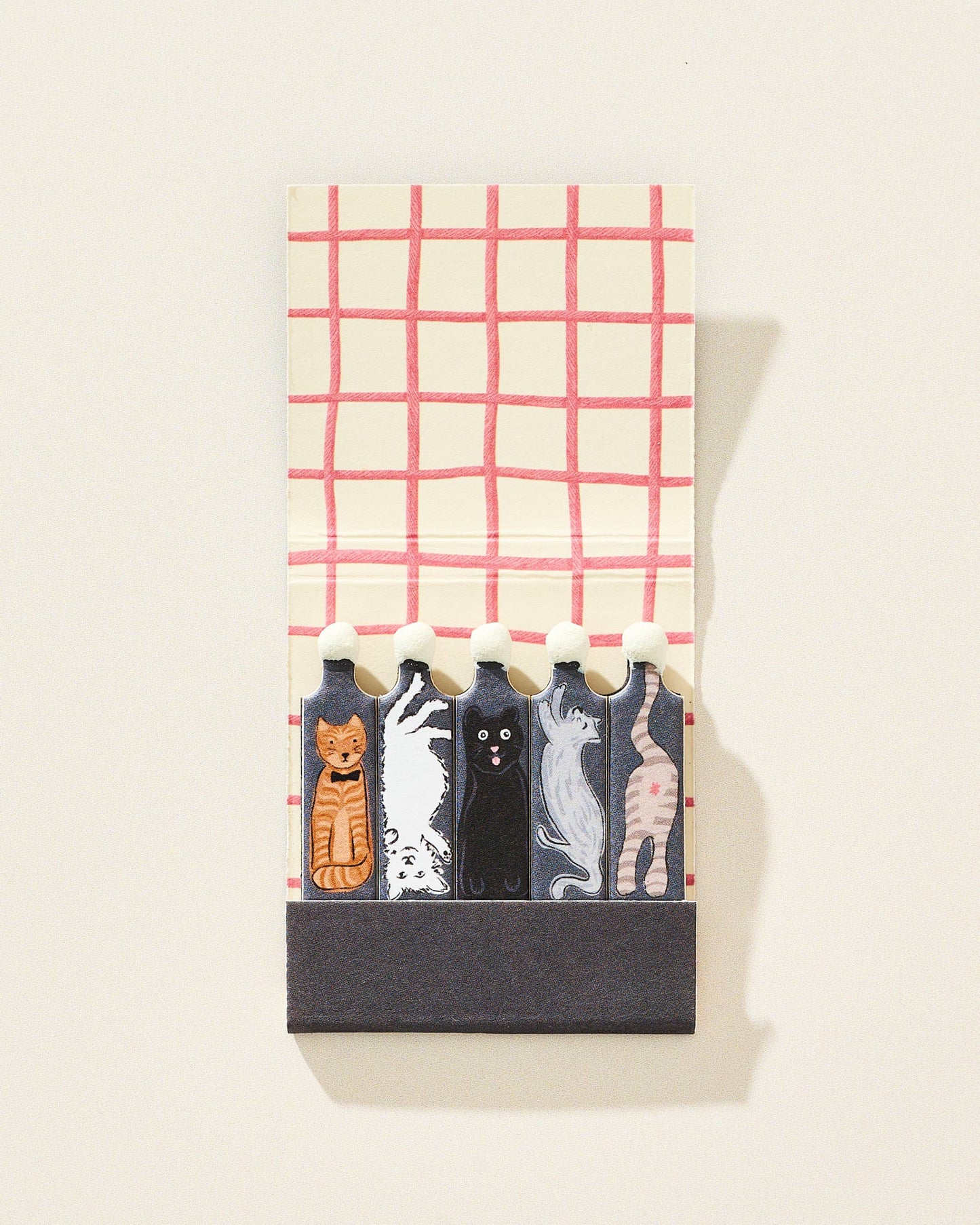 Set of cat-themed matches in a decorative holder with a plaid pattern on a white background.