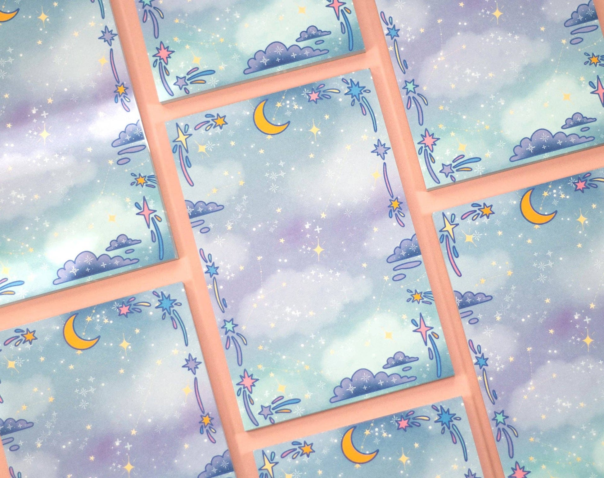 Pattern of celestial designs with moons, stars, and clouds on a pastel background.