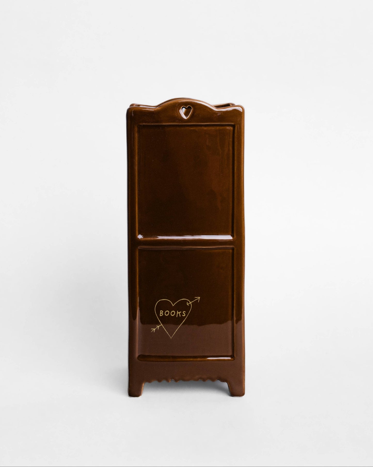 A small glossy dark brown wooden cabinet or organizer with two front compartments and a heart-shaped arrow graphic on the lower compartment, shown against a plain light gray background.