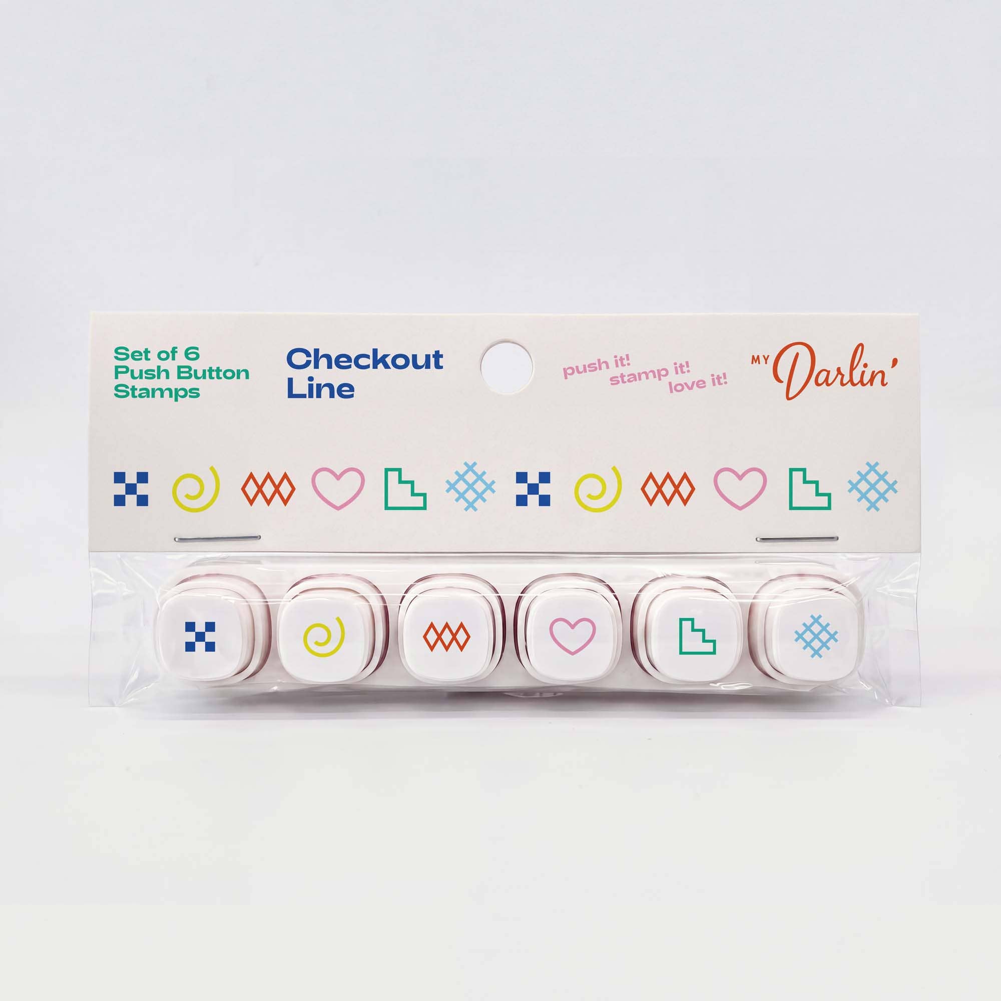 A set of six checkout push button stamps in a clear plastic clamshell package with a white cardboard header card. The stamps feature minimalist colorful icons including hearts, squares, spirals, and geometric shapes in blue, green, pink, yellow, and orange.