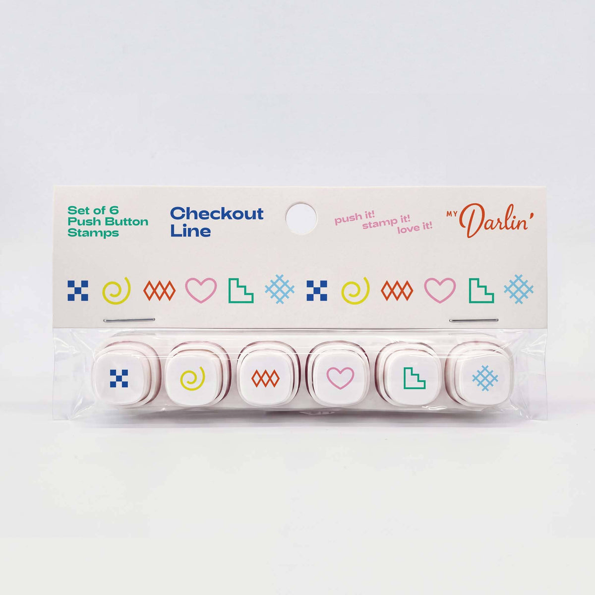 A set of six checkout push button stamps in a clear plastic clamshell package with a white cardboard header card. The stamps feature minimalist colorful icons including hearts, squares, spirals, and geometric shapes in blue, green, pink, yellow, and orange.