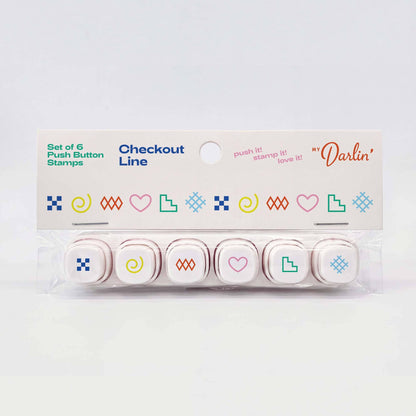 A set of six checkout push button stamps in a clear plastic clamshell package with a white cardboard header card. The stamps feature minimalist colorful icons including hearts, squares, spirals, and geometric shapes in blue, green, pink, yellow, and orange.