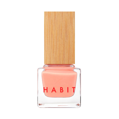 Pink nail polish bottle with wooden cap on a white background