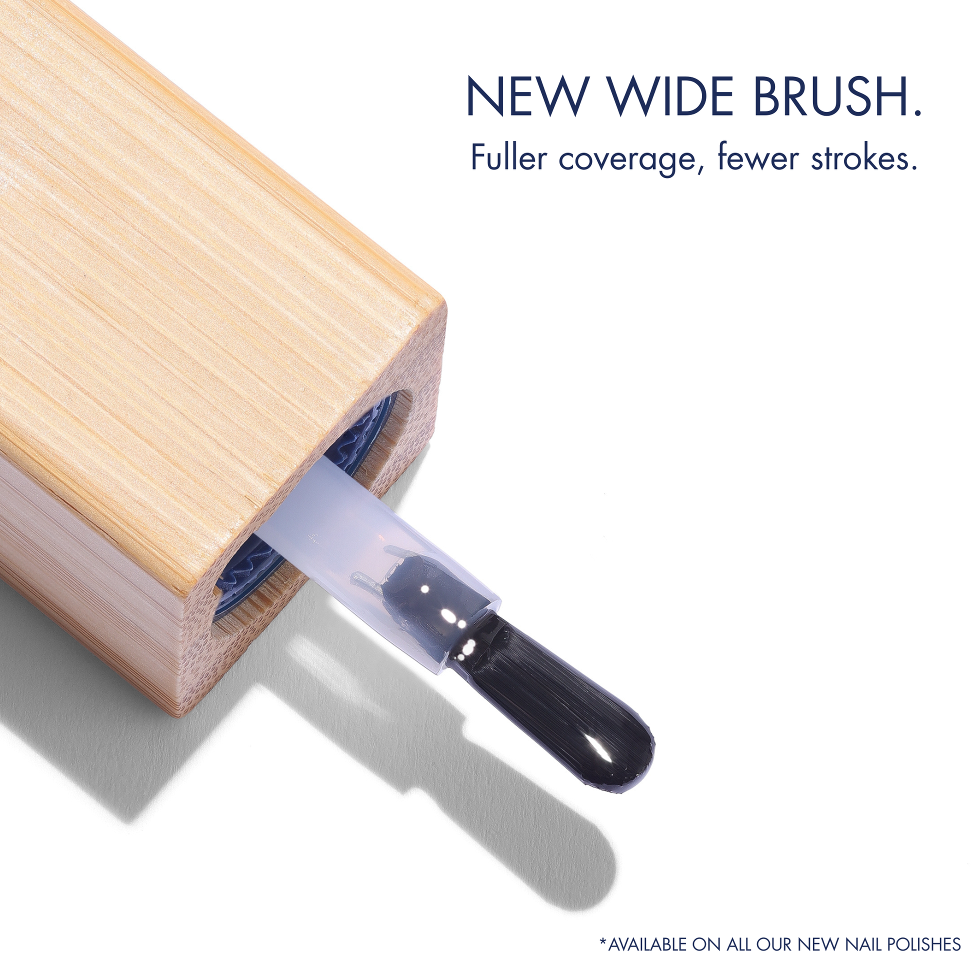 Wide brush applicator on a wooden block with text about new wide brush for nail polishes.