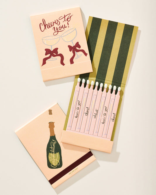 Set of cards with champagne bottle and bow designs on a light background