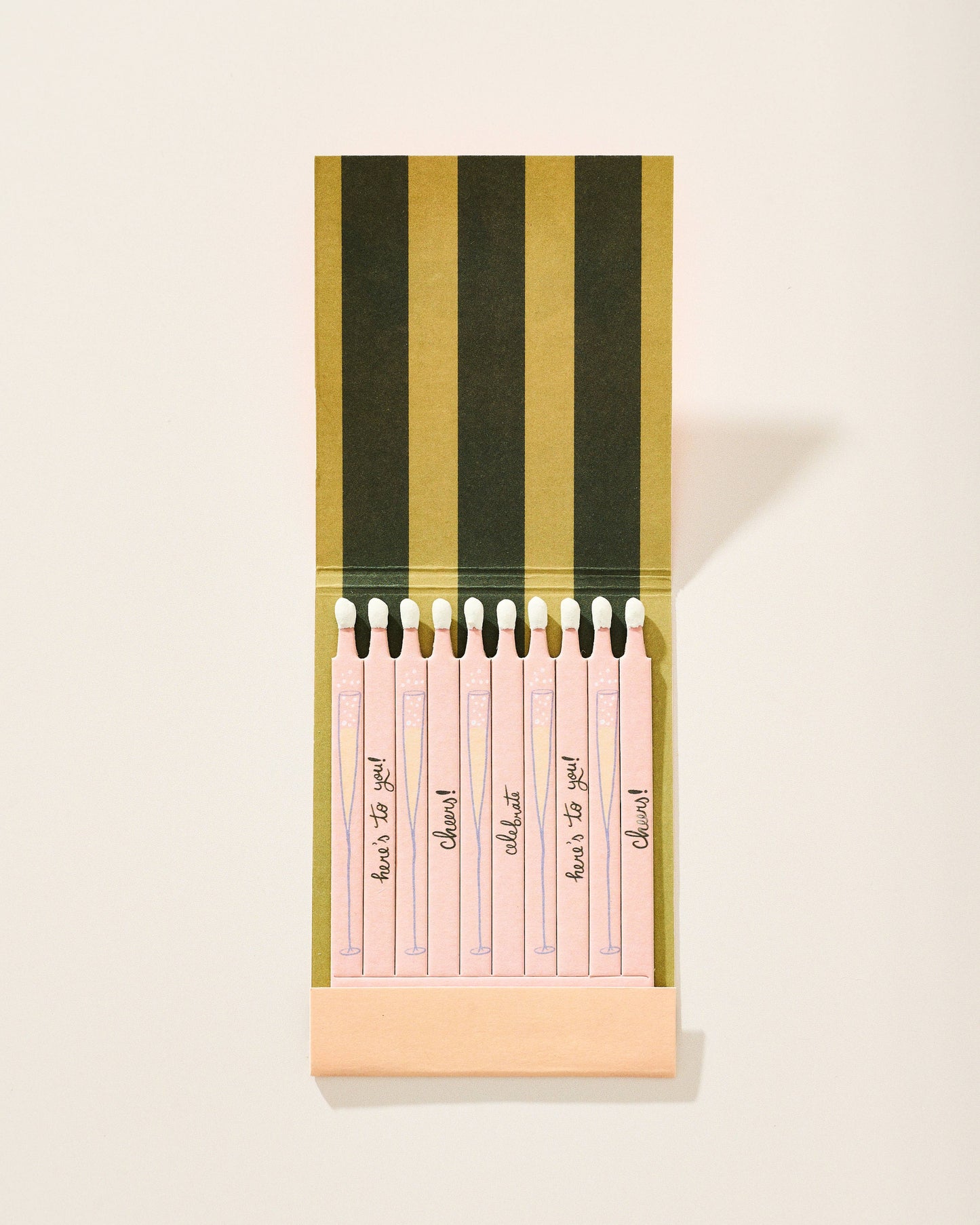 Set of pink notepads with black text in a striped holder on a light background