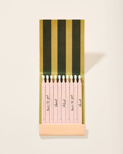 Set of pink notepads with black text in a striped holder on a light background