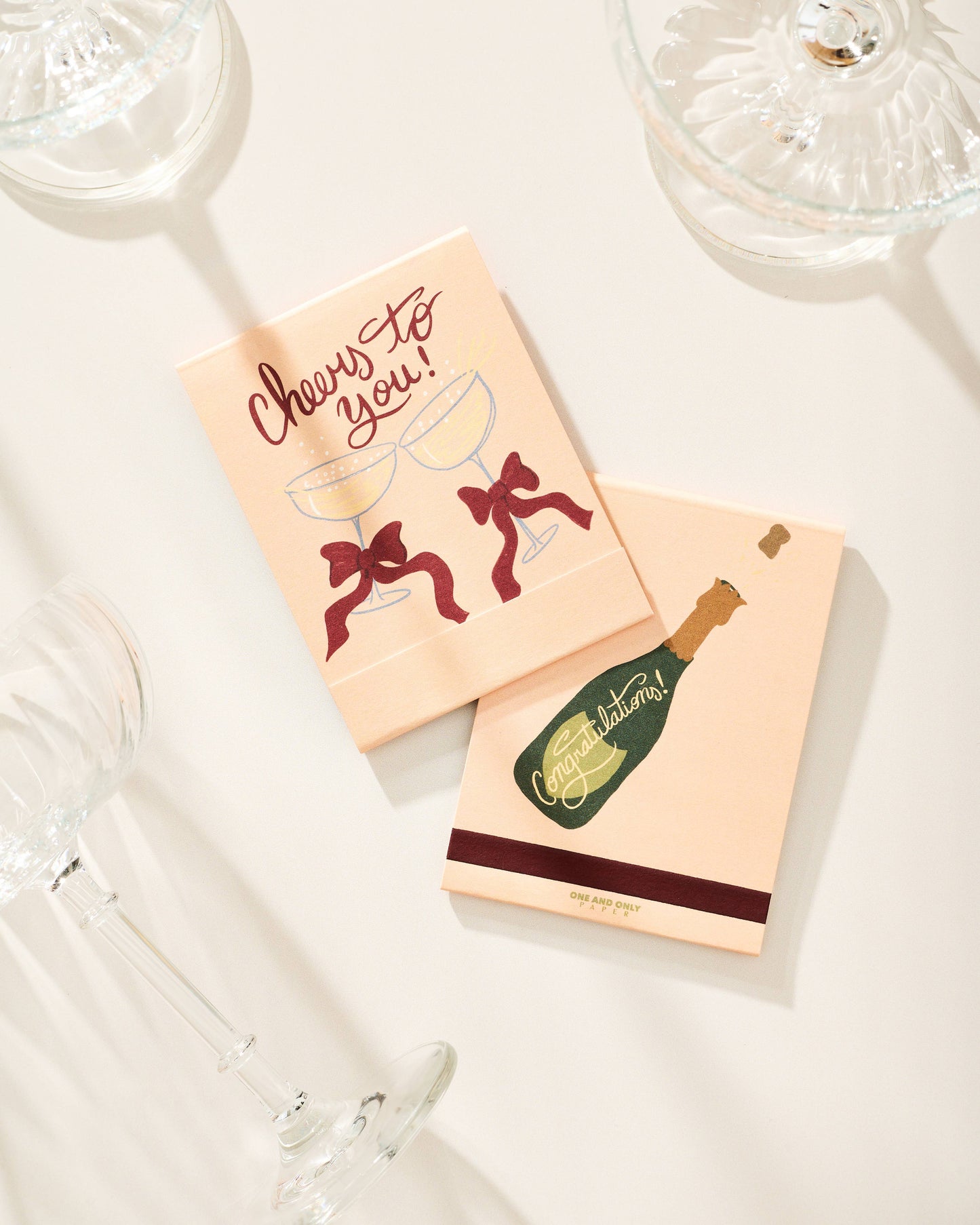 Two small books with festive designs on a light surface.