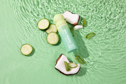 Skincare product with cucumber slices and aloe vera on a green water background