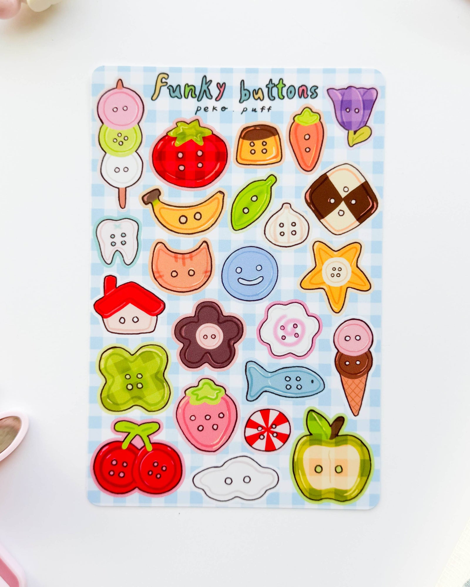 Sheet of colorful button stickers with various designs on a white background