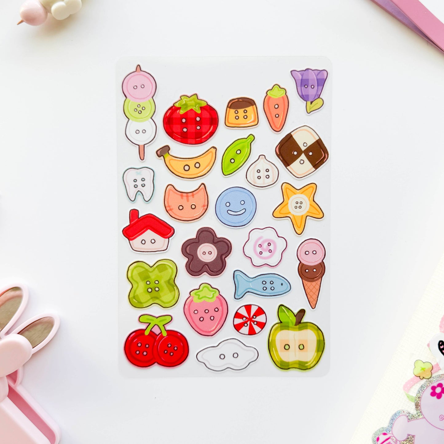 Sheet of colorful button stickers featuring various shapes and designs on a white background.