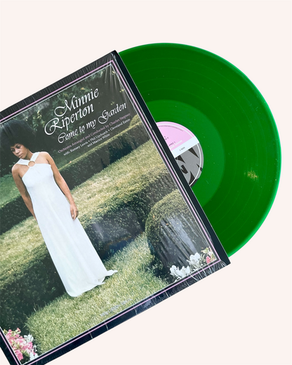 Vinyl record with green disc and cover featuring a woman in a white dress on grass. Come to My Garden Vinyl Record - Minnie Riperton