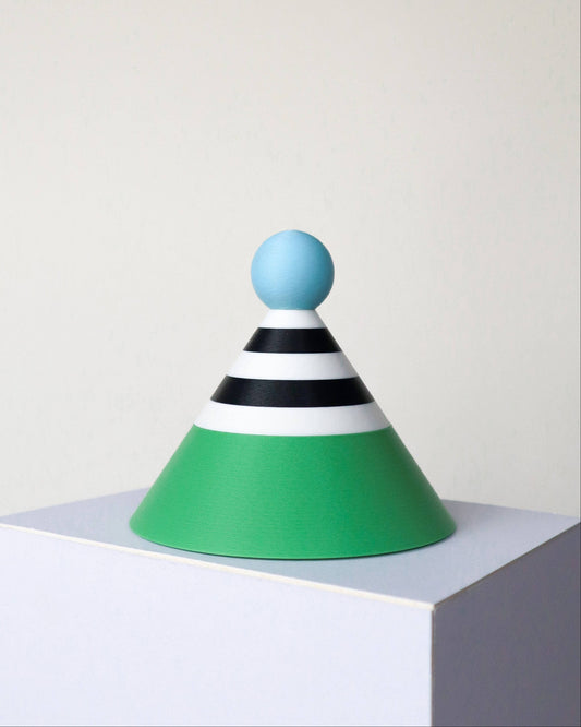 Colorful geometric lamp with a blue sphere on top against a white background
