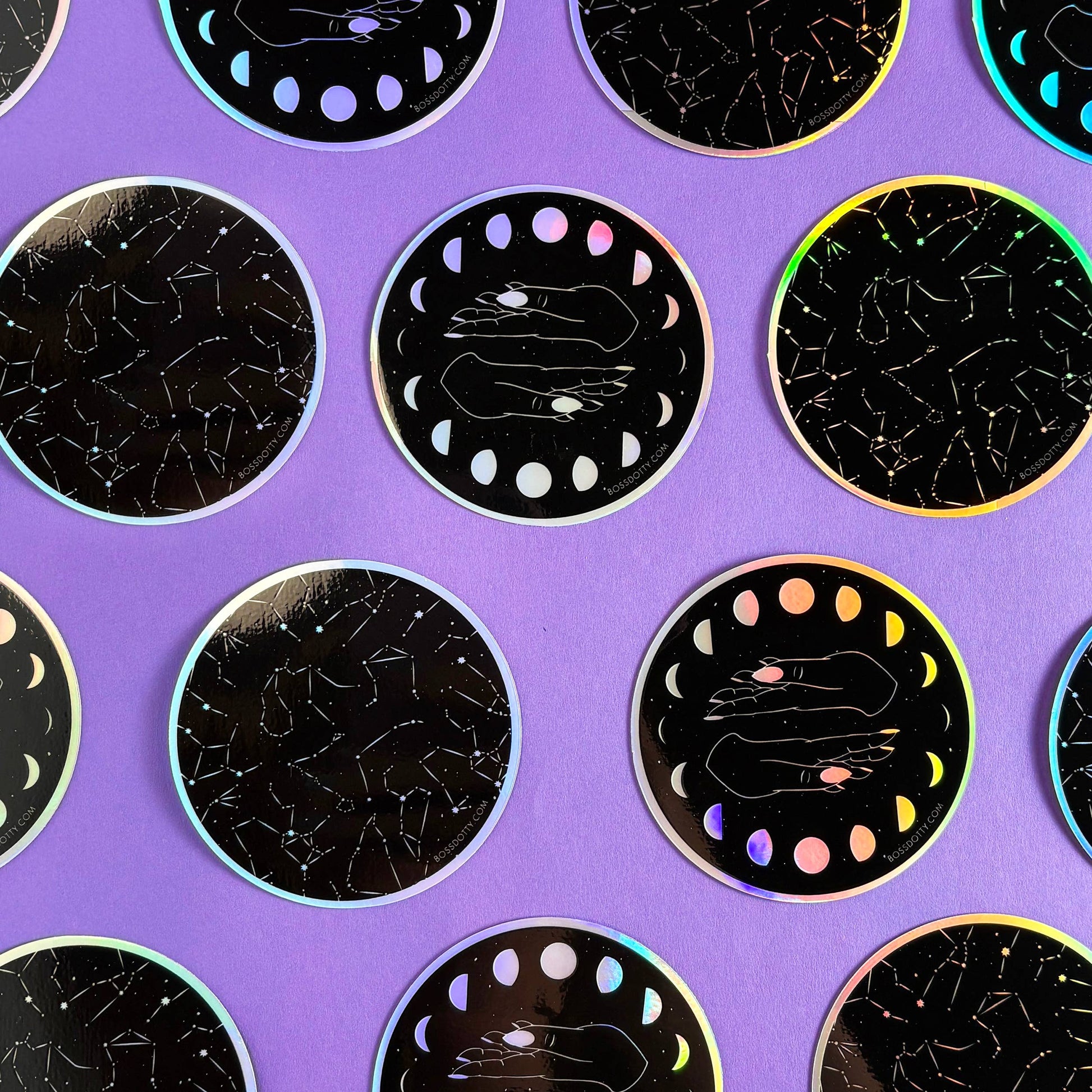 Circular stickers with celestial designs on a purple background