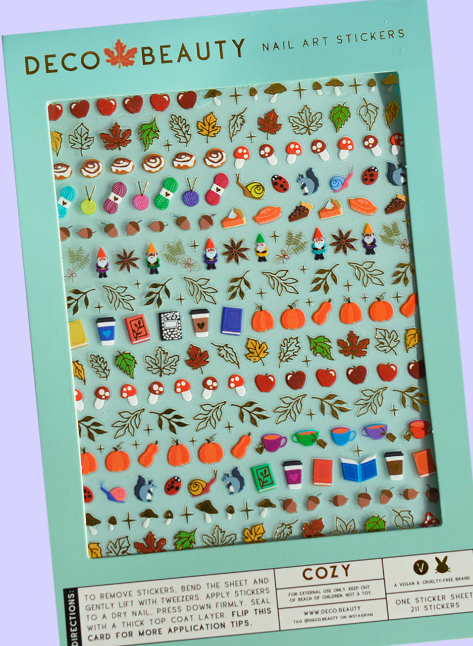 Packaging of Deco Beauty nail art stickers with various designs on a light green background. Cozy Fall Nail Art Stickers