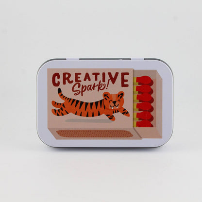 Tin box with a tiger illustration and 'Creative Spark!' text on a white background