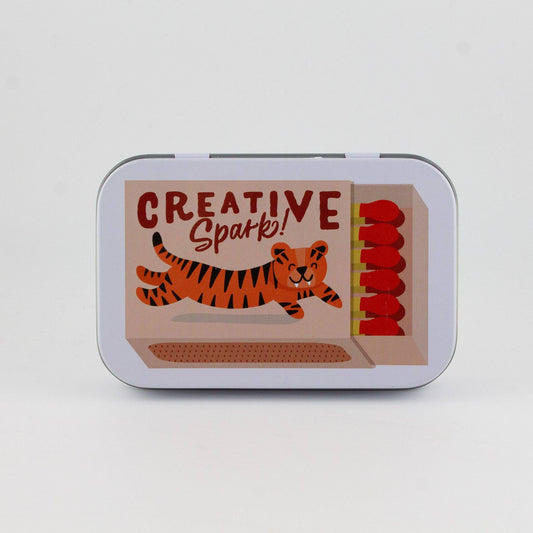 Tin box with a tiger illustration and 'Creative Spark!' text on a white background
