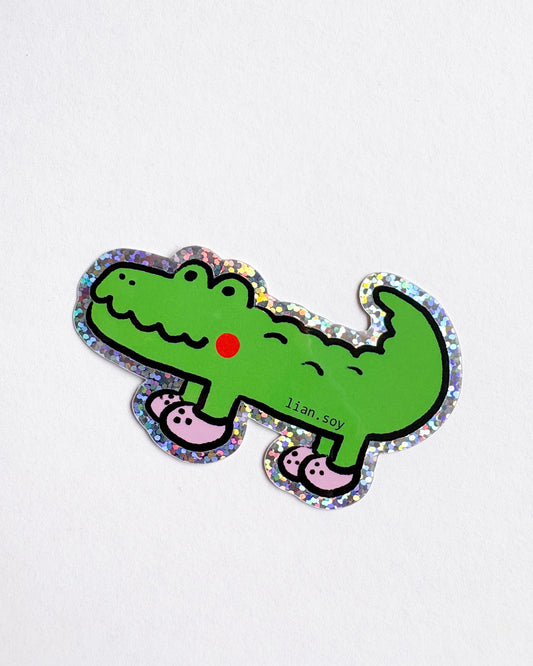 Cartoon crocodile sticker with colorful border on a white background