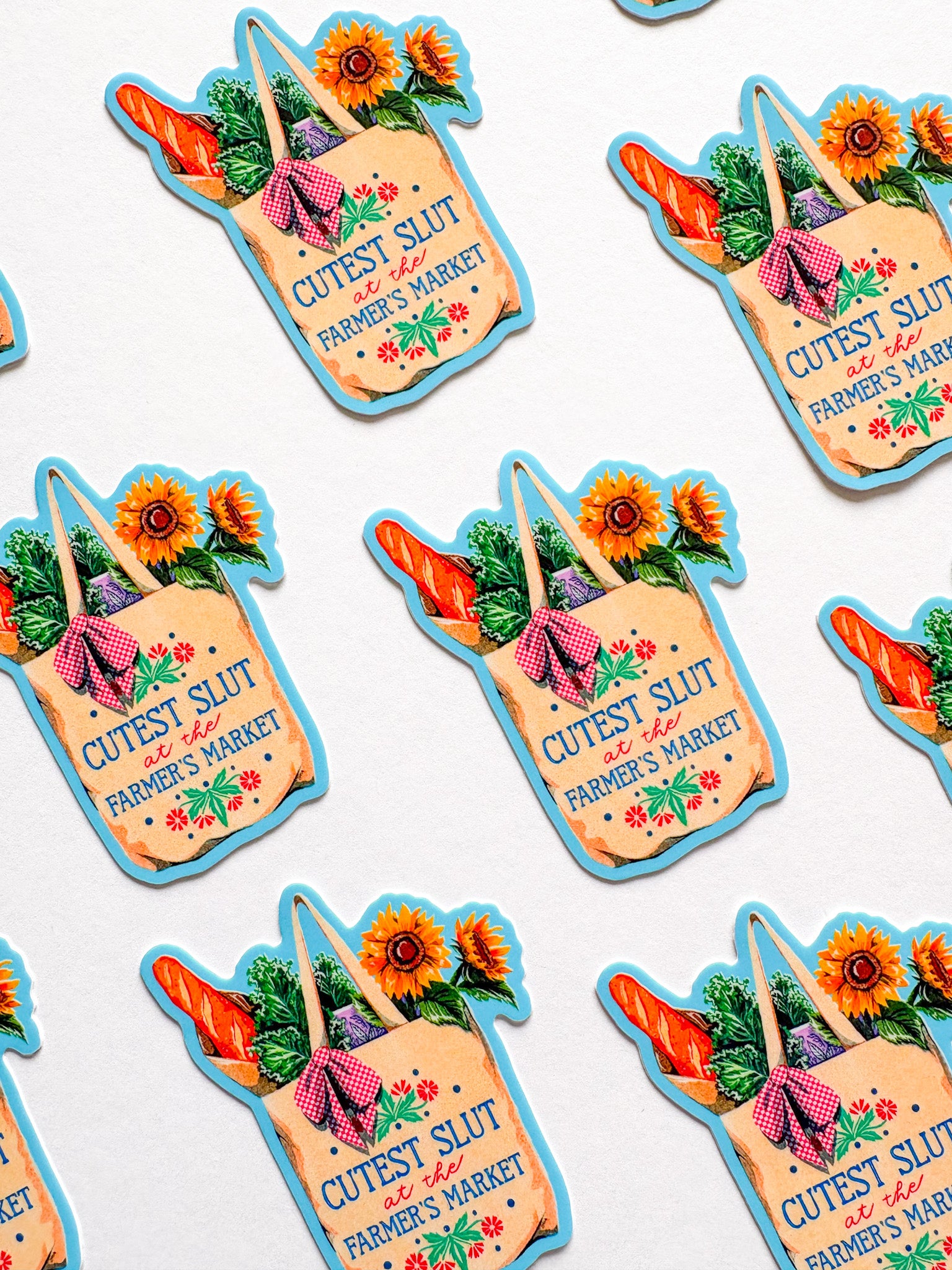 Stickers of a shopping bag with vegetables and flowers, labeled 'Cutest Slut at the Farmer's Market'.