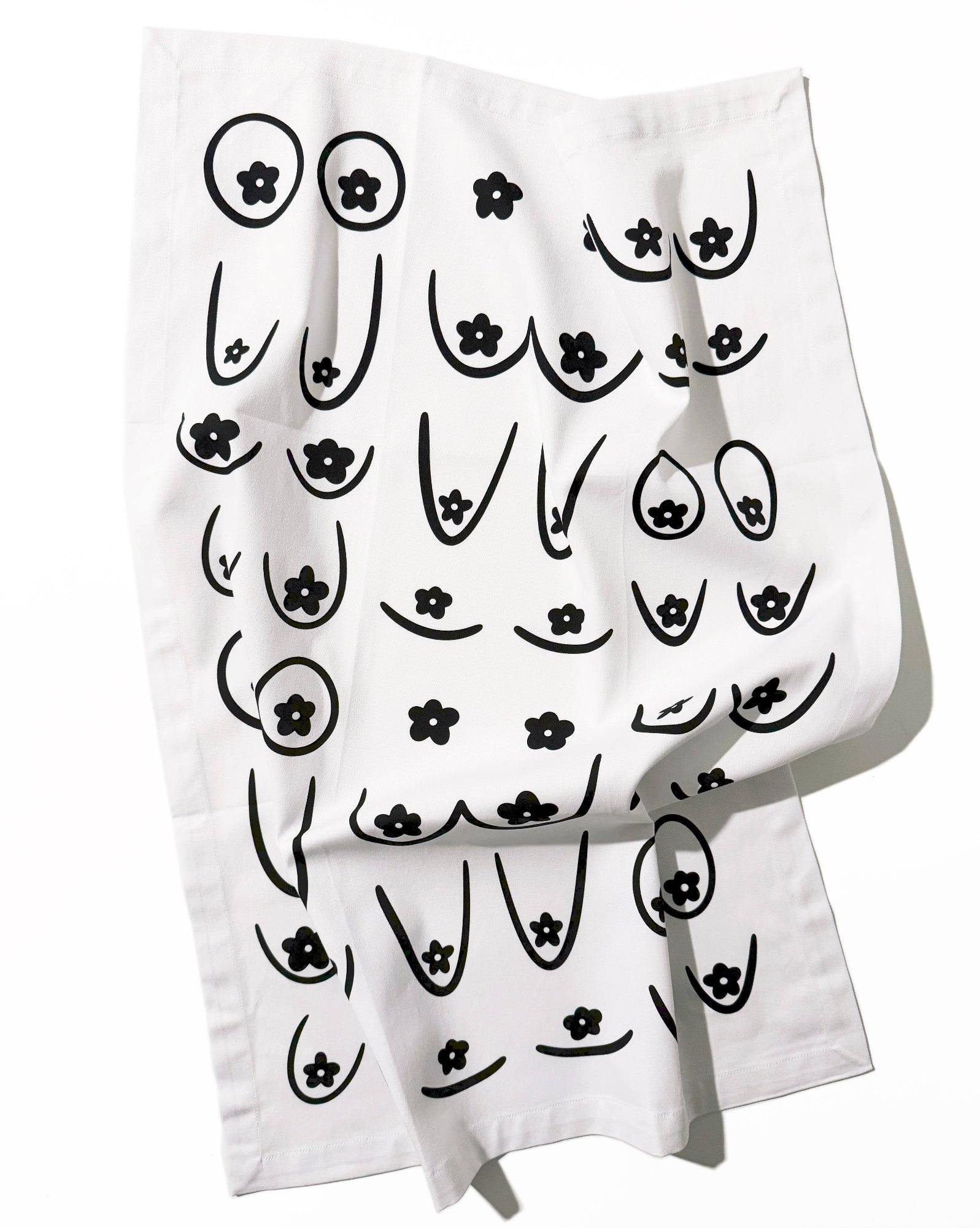 White towel with black abstract designs on a white background, Daisy Boob Kitchen Tea Towel
